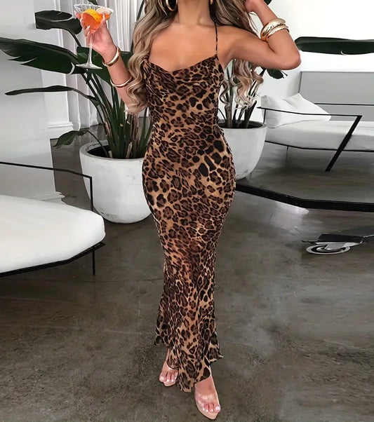 Person wearing a leopard print dress in an indoor setting