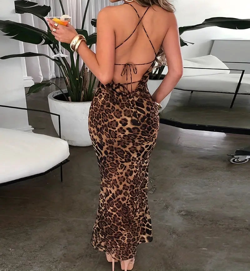 Person wearing a leopard print dress in an indoor setting